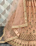 Peach net embroidered Lehenga Choli and Dupatta set, perfect for festive occasions