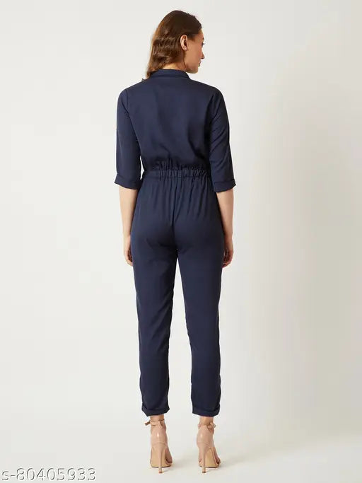 Navy blue crepe women's Miss Chase jumpsuit with round neck & three-quarter sleeves, solid design, buttoned closure, two side pockets, tie-up detailing. Made in India