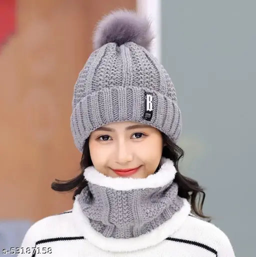 A winter accessory set featuring a grey ball cap with an inside fur trim, a soft warm woolen beanie scarf, and a matching fleece knitted cap. Perfect for cold winter weather, providing protection from snow and air