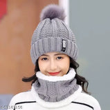 A winter accessory set featuring a grey ball cap with an inside fur trim, a soft warm woolen beanie scarf, and a matching fleece knitted cap. Perfect for cold winter weather, providing protection from snow and air