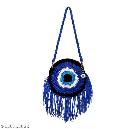 Royal blue fringe sling bag with metal eye accent