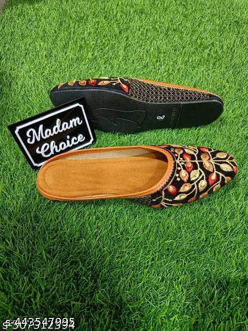 Tan Badami slipper with a brown sole, red piping trim, and a black logo on the inside