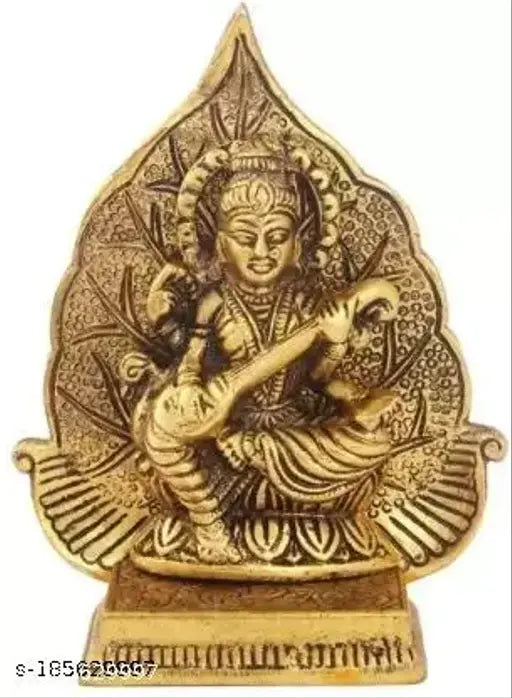 Antique golden metal figure of Hindu deity Saraswati, playing a string instrument, with a leaf backdrop. 13cm height