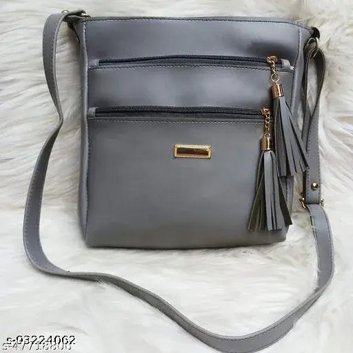 Grey faux leather crossbody purse with tassel detail