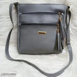 Grey faux leather crossbody purse with tassel detail