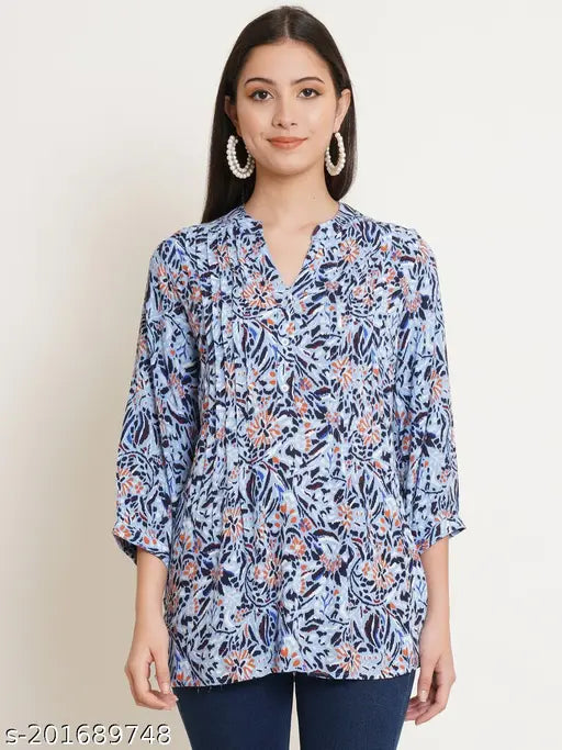 Blue viscose rayon women's top with embroidered net print, longline design, and mandarin collar. Sizes: S, M, L, 7XL, 9XL. Made in India