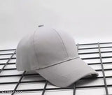 Grey cotton baseball cap for men and women, solid design with buckle strap closure, fashionable accessory from India
