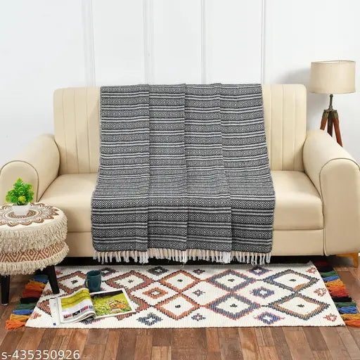 Black and White geometric-patterned HomewayTex 100% cotton throw, suitable for indoor/outdoor use as a sofa cover, bedspread, or blanket. Breathable, lightweight, reversible, soft, easy to maintain, stylish. Machine wash in cold water or hand wash; hang dry. Origin: India