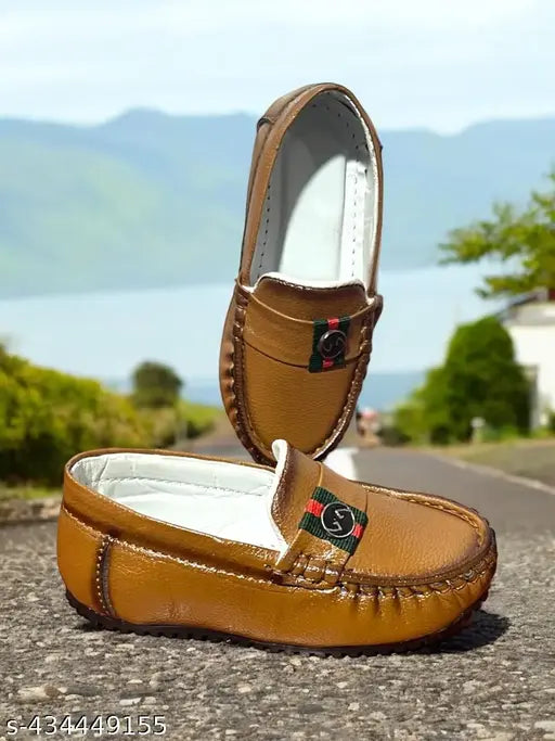Brown leather loafer shoes with a logo on the strap
