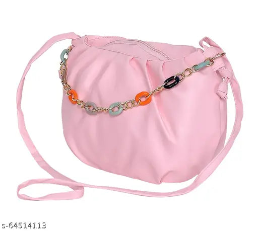 A pink sling bag with a chain shoulder strap