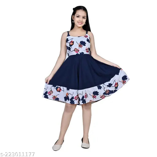 Teen girl in navy blue floral print dress with fitted waist, short sleeves, and A-line skirt, standing against white background