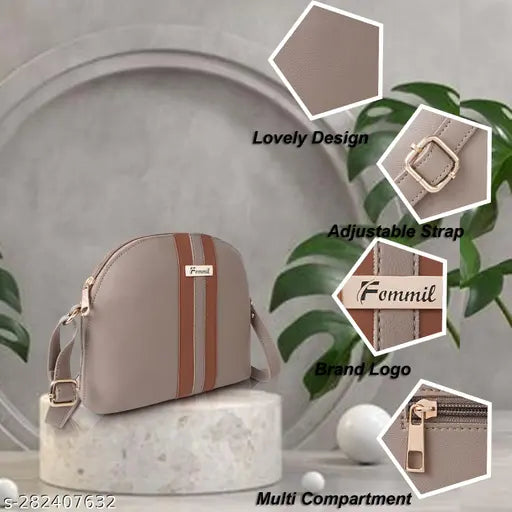 The image displays a dark-colored sling bag with visible stitching, resting on a surface with a plant and a small object. The text "Fommil" is present near the top of the image, suggesting it could be a brand name, and there's a metallic clasp that serves as a closure mechanism
