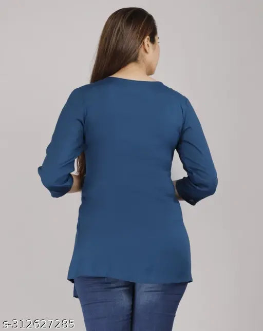 Teal blue rayon short kurta, three-quarter sleeves, embroidered pattern. Single size options: S (Bust 36in), M (Bust 38in), L (Bust 40in), XL (Bust 42in), XXL (Bust 44in). Latest trending tops for girls by Suraj Pari Singh, high-quality embroidered kurta from India