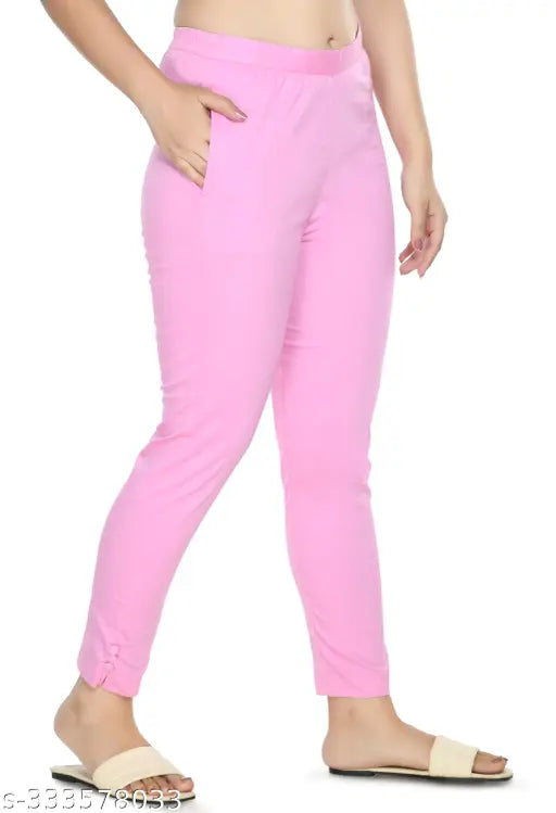 Baby pink solid cropped cigarette trousers by Preego, women's slim fit cotton blend trousers with half elasticated waistband, available in various sizes from 26-44 inches