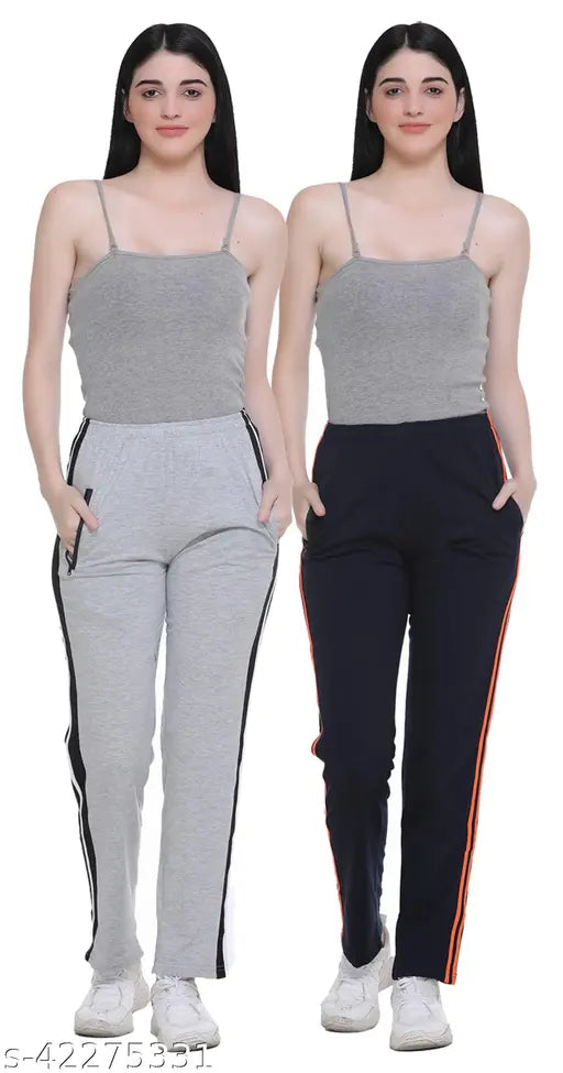 A set of two women's casual track pants in a solid white color with black side stripes