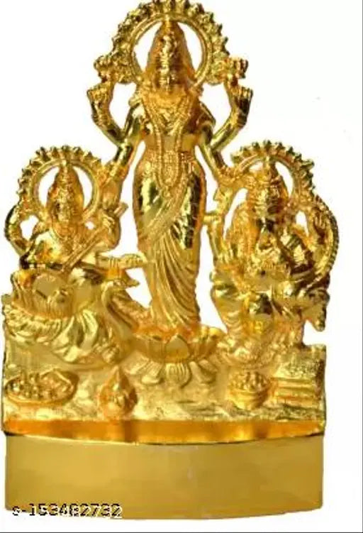 Golden metal statue of deities Saraswati, Lakshmi and Ganesha