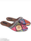 Synthetic open-back mojari flat bellies for women, ethnic Indian footwear on display