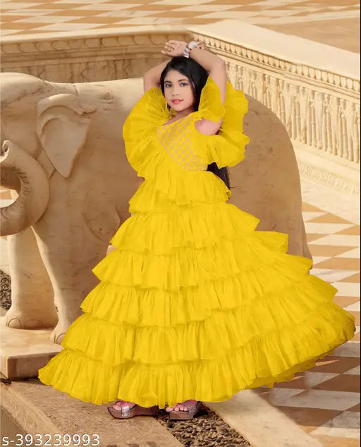 Party gown for kids, net floral ballgown with short sleeves. Indulgent piece from B.R. Enterprise's collection, perfect for birthdays or special occasions. Sizes range from 5-16 years. Made in India