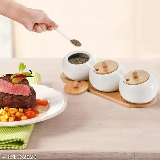Ceramic condiment set with serving tray and multiple storage jars, table salt and pickle containers on dining table