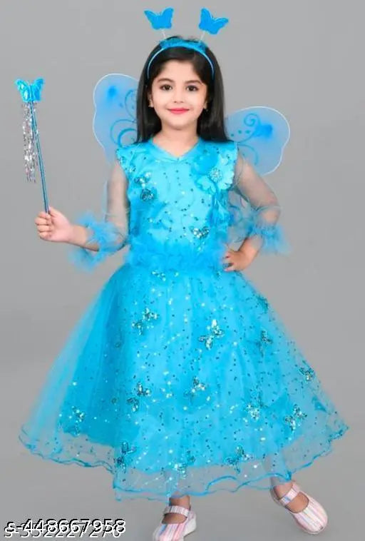 A young girl in a blue sequined princess costume with a magic wand