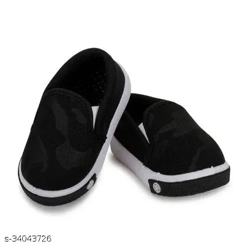 The image shows a pair of black casual slip-on boots, possibly featuring a patterned trim