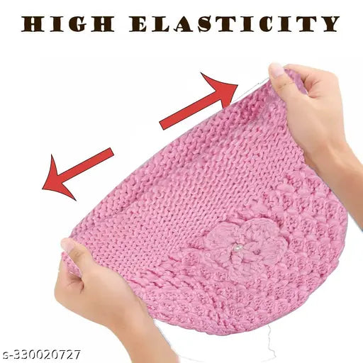 A person holding a pink knitted cap