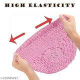 A person holding a pink knitted cap