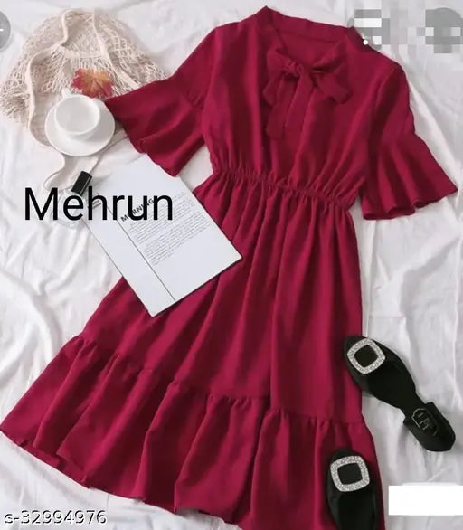 Red cotton midi dress with off-the-shoulder puffed sleeves, knee-length skirt, and black belted waist