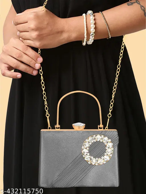 Black clutch with diamond frame and strap, featuring a white chain