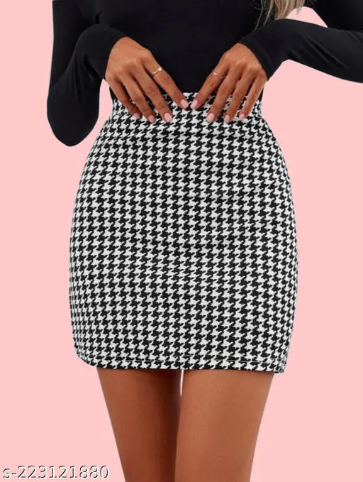 A woman in black high heels poses against a pink background, wearing a black and white checkered skirt