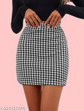 A woman in black high heels poses against a pink background, wearing a black and white checkered skirt
