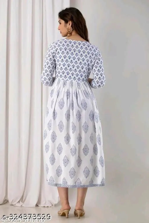 Long, white, flared dress with a lace-like pattern, sleeveless design