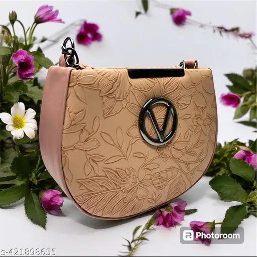 Pink floral patterned sling bag, with a circular emblem on it