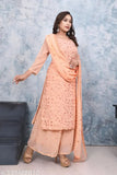 Amber-colored georgette embroidered kurti with sharara and duppatta, paired with heels