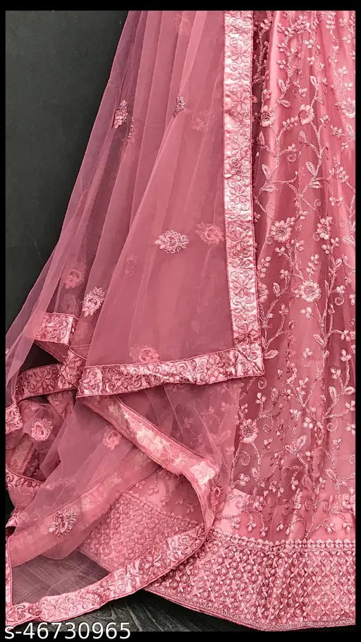 Elegant pink net semi-stitched Lehenga Choli with extra inner and dupatta, ideal for weddings, festivals, parties. Embroidered design in Indian tradition