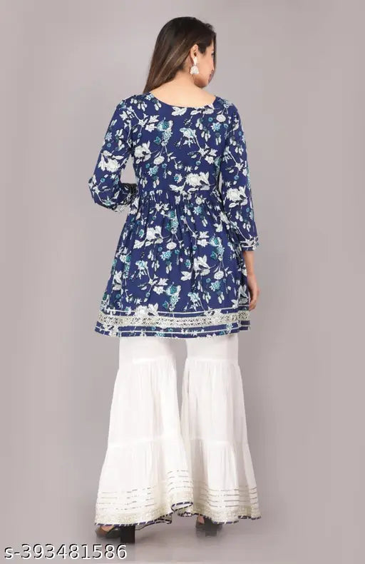 A woman wearing a blue print outfit with ruffled pants, midriff style