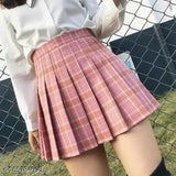 This is an image of a woman wearing a pleated mini skirt with a plaid pattern. The skirt has a high waist design, and it appears to be made from a fabric that might be similar to denim or a denim-like material