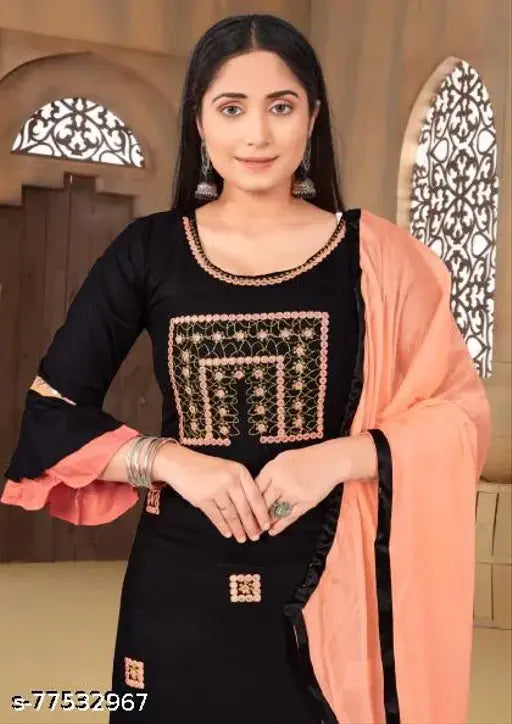 Black embroidered dupatta with a light beige or pink blouse