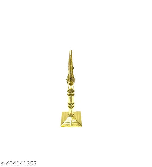 A brass colored decorative om symbol for cars and temples, likely placed on a dashboard