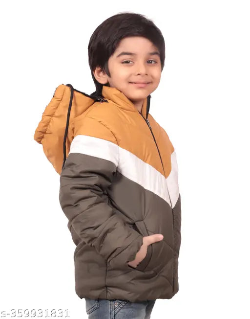 A boy wearing a tan, black and white puffy winter jacket