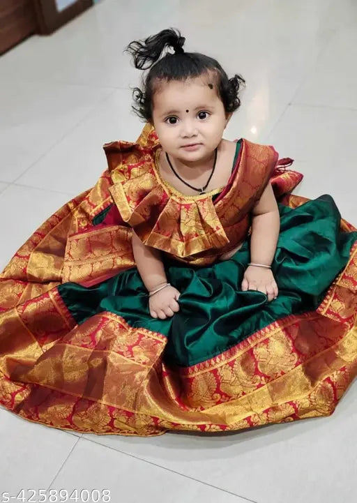 New Traditional kids unstitched half saree, litchi silk in free size. Unstitched blouse and dupatta with woven design, tassels included. Beautifully accessorized with a belt. Indian-origin traditional wear for little girls