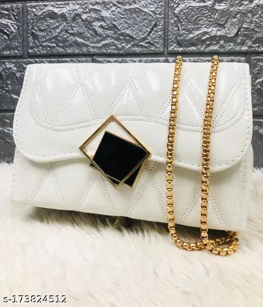 White leather cross body bag with gold chain details and a black diamond-shaped hardware accent