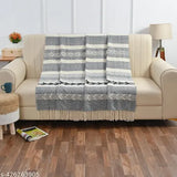 Navy blue cotton horizontally folded throw for sofa or bed, designed in a blanket style with fringes