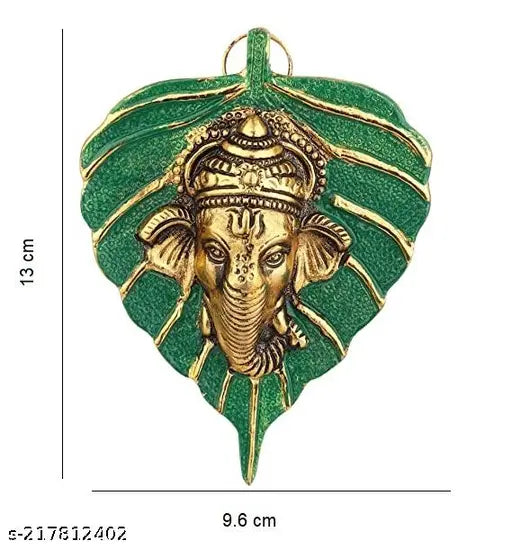 Handcrafted green Peepal leaf Ganesh idol, gold-plated with antique finish. Traditional decorative wall hanging for worship or home decor. Made in white metal with silver antique finish. Indian artistry and ideal gift