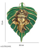 Handcrafted green Peepal leaf Ganesh idol, gold-plated with antique finish. Traditional decorative wall hanging for worship or home decor. Made in white metal with silver antique finish. Indian artistry and ideal gift