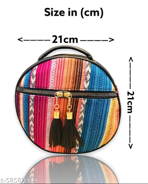 A small, vibrant colorful fabric sling bag with a metal zipper and black faux leather details