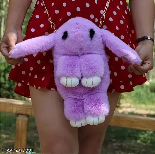 Purple plush toy bunny charm attached to a black strap crossbody bag, girl's fashion accessory