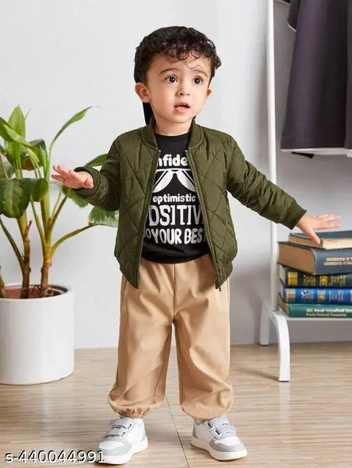 Boy in green bomber jacket standing near a potted plant