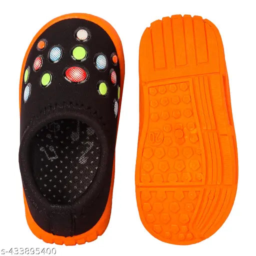 Neon orange and black shoes with multiple patterns and dots