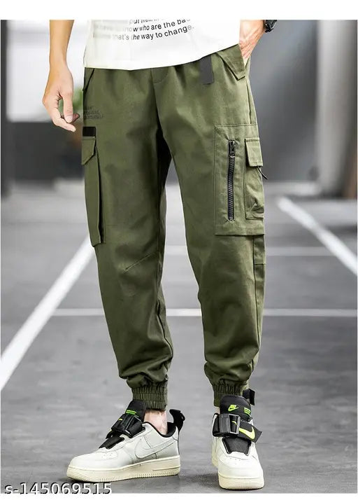 Men's green cargo pants with flap pocket, zip detail, and drawstring waist
